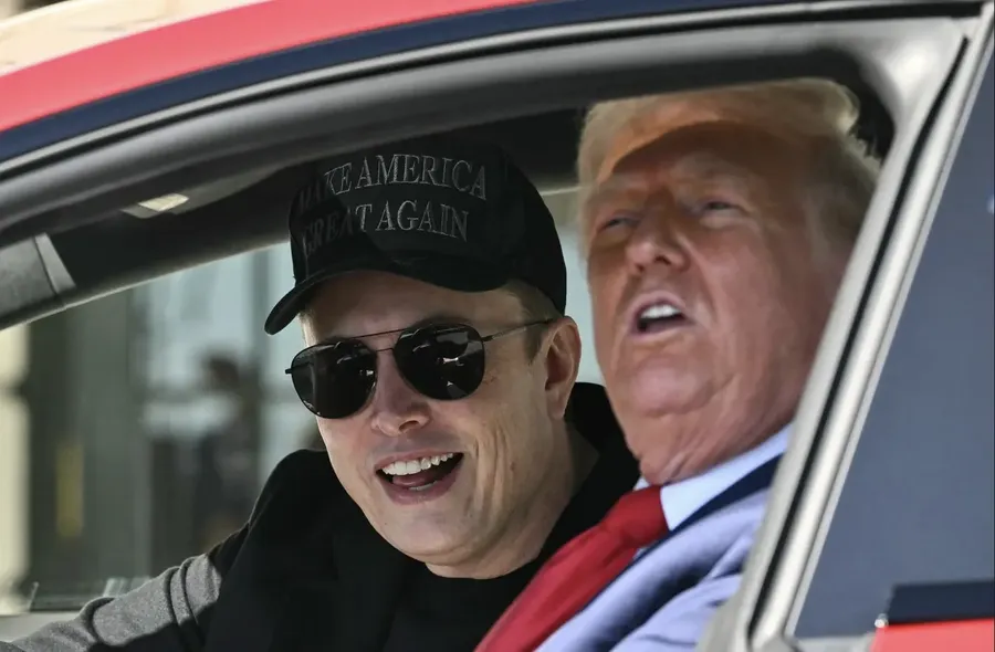 Musk and Trump inside of a red Tesla Model S
