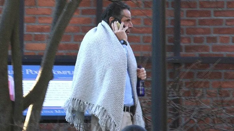 New York Governor Andrew Cuomo walks on the grounds of the Governor's Mansion