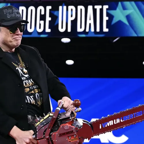Elon Musk holds a chainsaw reading 'Long live freedom, damn it'