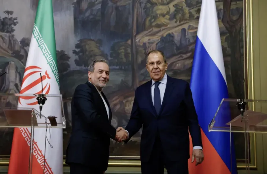 Russia's Foreign Minister Sergey Lavrov, right, and Iran's Foreign Minister Abbas Araghchi shake hands during a meeting in Moscow, Russia