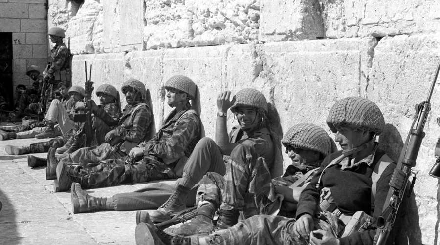 Israeli soldiers sit in front of the Western Wall in Jerusalem's Old City.